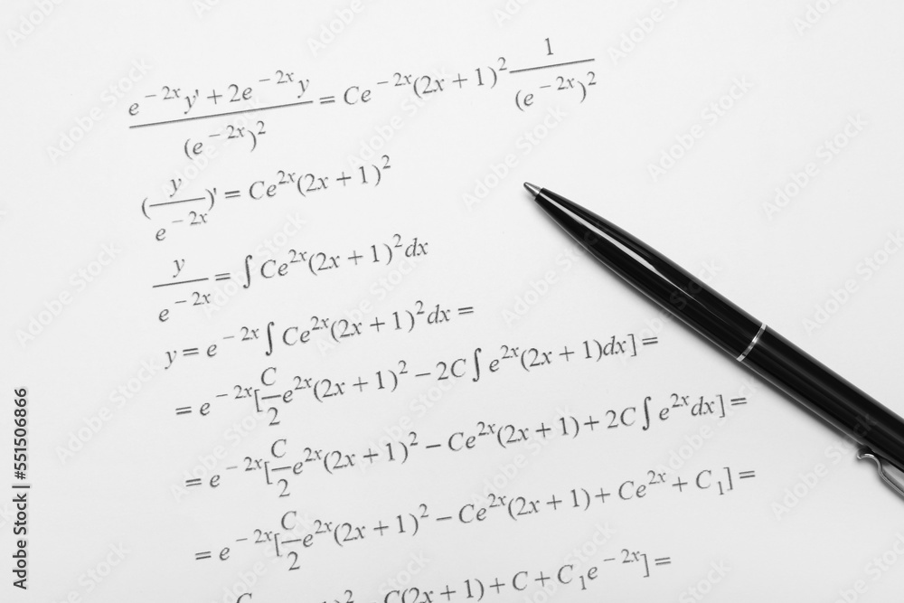 Sheet of paper with mathematical formulas and pen Sheet of paper with mathematical formulas and pen