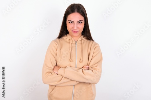 Young caucasian woman wearing sweatshirt over white background Pointing down with fingers showing advertisement, surprised face and open mouth