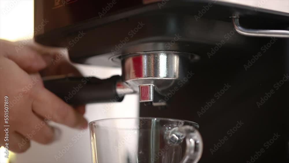 Close-up shot insert a grinded coffee beans in the portafilter and put it in the coffee machine. Preparing to make a fresh coffee Close-up shot insert a grinded coffee beans in the portafilter and put it in the coffee machine. Preparing to make a fresh coffee