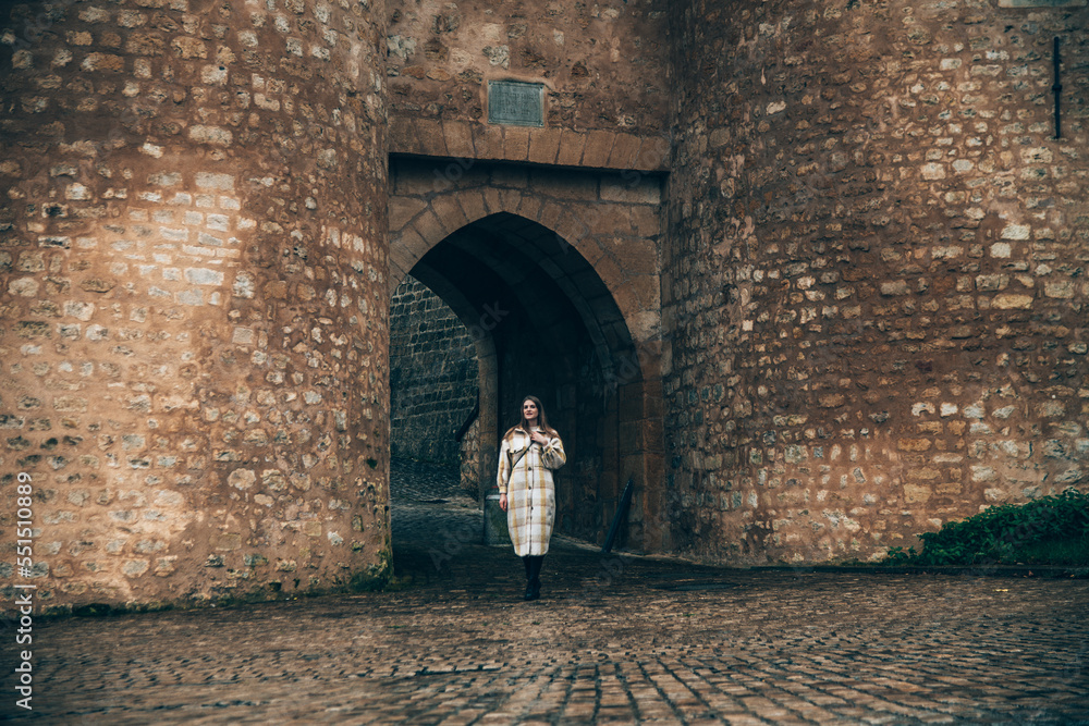 Girl in front of the entrance gate of the old city in Luxembourg