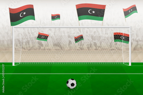 Libya football team fans with flags of Libya cheering on stadium, penalty kick concept in a soccer match.