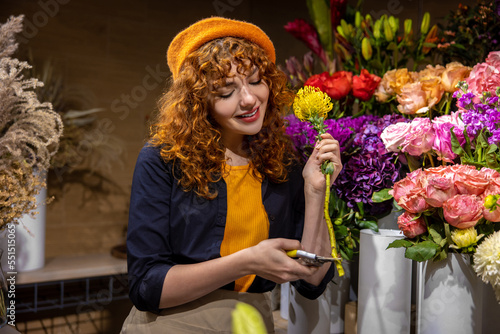 Pretty florist sorting the flowers and looking involved photo