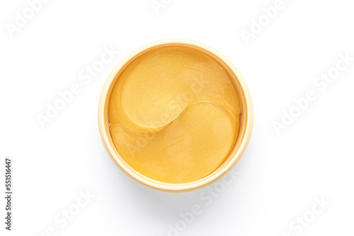Cosmetic golden patches in jar on white background. Isolated beauty product for eyes on white background photo