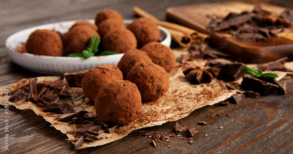 Homemade Chocolate Truffles with Cocoa Powder on Brown Wooden Table. Homemade Chocolate Truffles with Cocoa Powder on Brown Wooden Table.