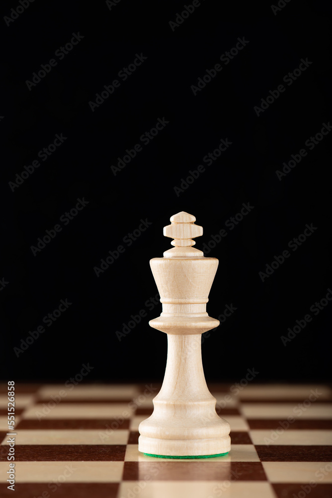 Light chess king on a wooden chessboard. Leadership, fighter, competition, confrontation concept. Light chess king on a wooden chessboard. Leadership, fighter, competition, confrontation concept.