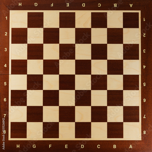 Empty wooden chess board, top view.