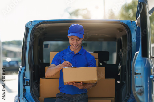 Asian courier with parcel and delivery logistic concept. Delivery man using digital tablet