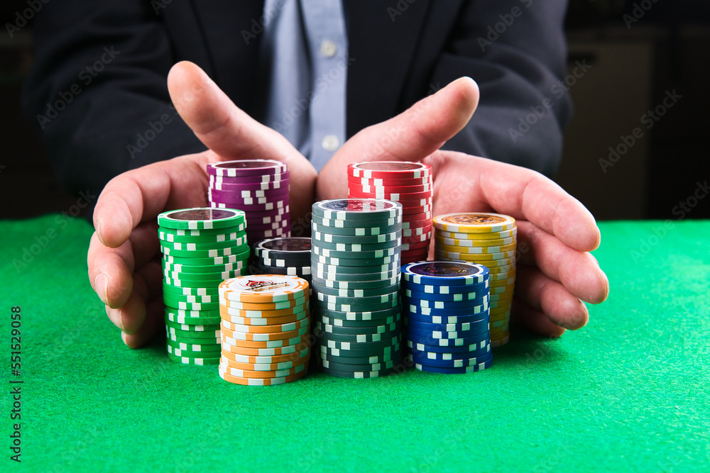 man play poker with cards and chips on a green table man play poker with cards and chips on a green table