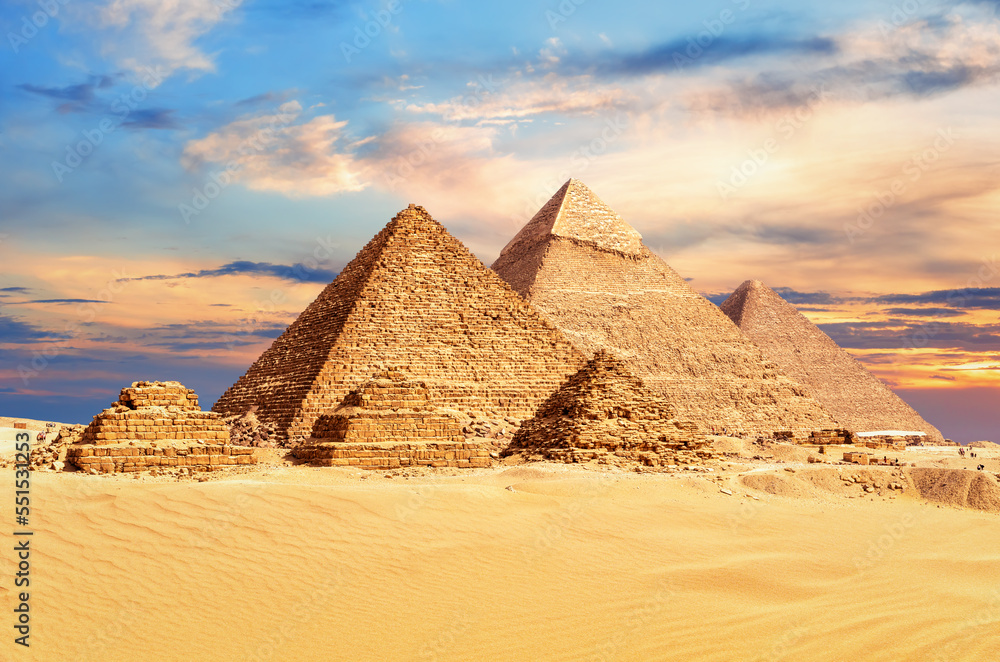 The Great Pyramids of Giza under a colorful desert sky, Egypt