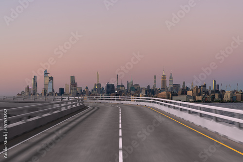 Empty urban asphalt road exterior with city buildings background. New modern highway concrete construction. Concept of way to success. Transportation logistic industry fast delivery. New York. USA.