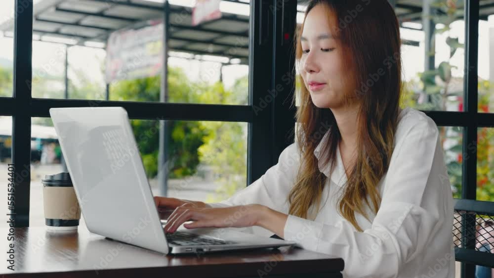 Happy beautiful freelancer blogger typing keyboard on laptop for writing blog web page, working online, Asian young business woman lifestyle sitting using laptop computer at cafe coffee shop Happy beautiful freelancer blogger typing keyboard on laptop for writing blog web page, working online, Asian young business woman lifestyle sitting using laptop computer at cafe coffee shop
