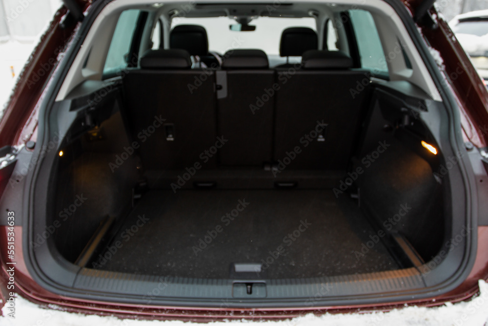 Huge, clean and empty car trunk in interior of compact suv. Rear view of a SUV car with open trunk