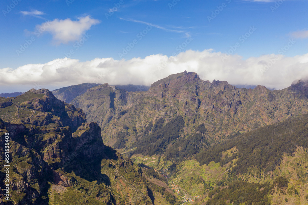 Obraz premium Drone view of mountains buried in clouds