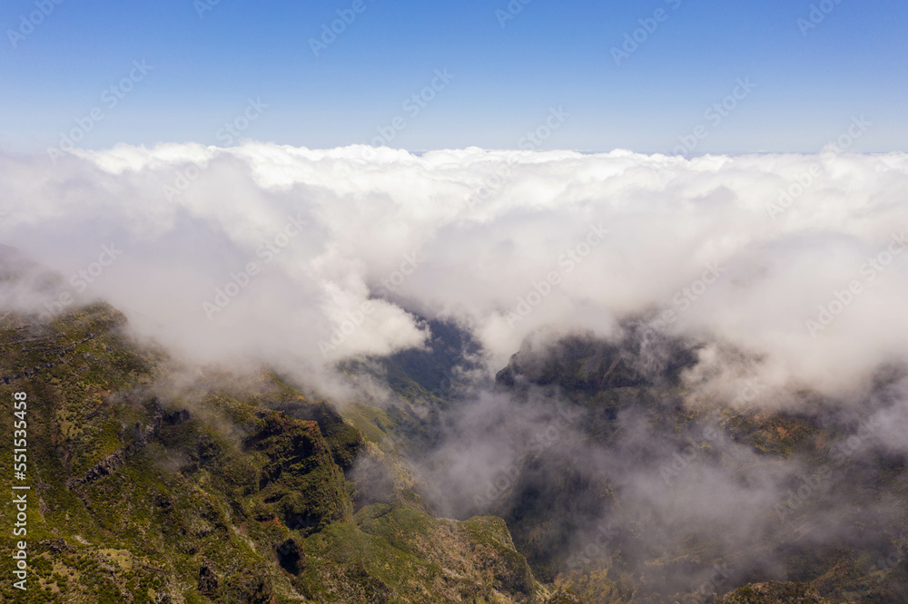 Drone view of mountain peak submerged in fog