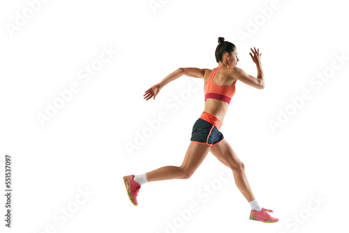 Dynamic portrait of professional female athlete, runner or jogger wearing summer sportswear running isolated on white background. Sport, fitness, motion, competition