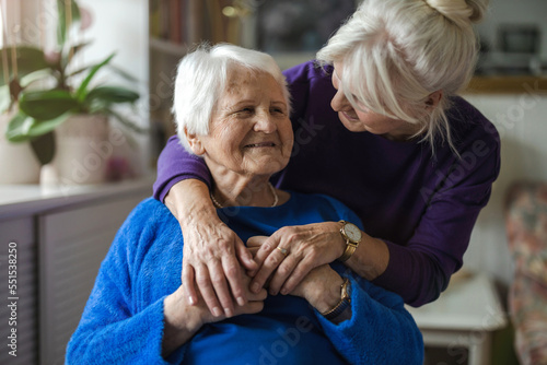 Woman hugging her elderly mother
