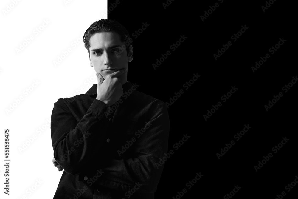 Black and white portrait of young man in classical shirt posing. Serious look. Concept of men's fashion, business, emotions Black and white portrait of young man in classical shirt posing. Serious look. Concept of men's fashion, business, emotions