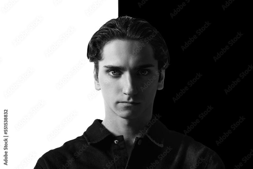 Black and white portrait of young man in classical shirt posing. Seriously looking at camera. Concept of men's fashion, business, emotions