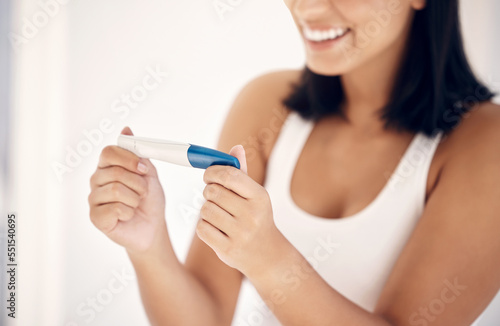 Good news, smile and woman with pregnancy test in bathroom happy, excited and celebrate positive results. Fertility, love and pregnant woman ready for motherhood and future children, family and baby