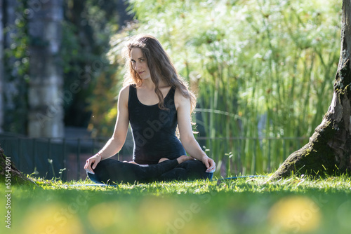 Wallpaper Mural Beautiful flirty woman sitting in the lotus position on yoga mat and looking in the camera Torontodigital.ca