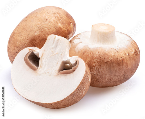 Brown cap champignons with slice of champignon mushroom isolated on white background. Close-up.