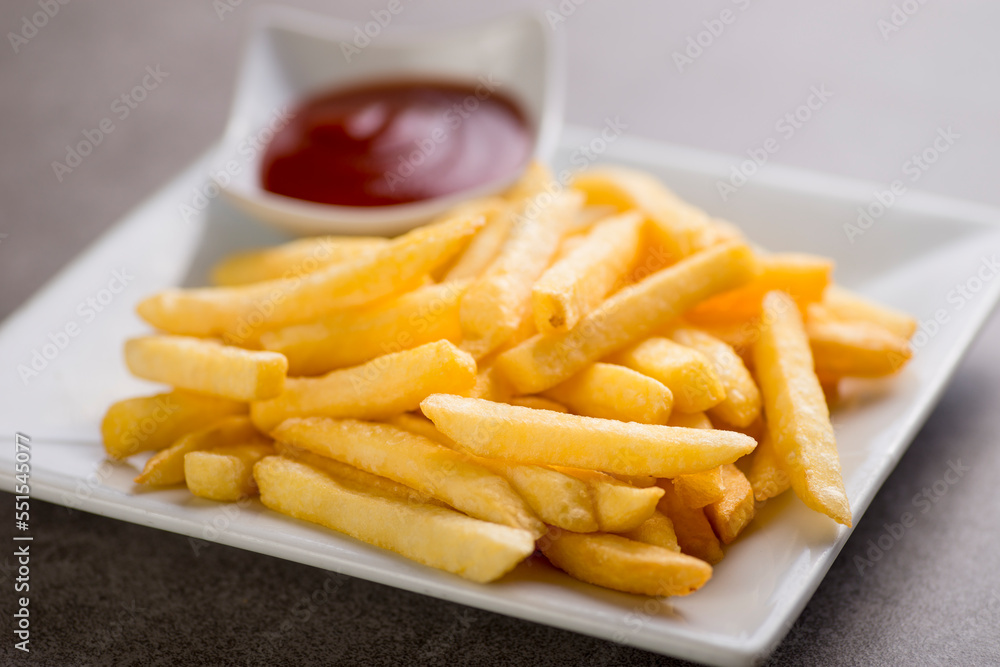 Potatoe fries with tomato sauce served in dish isolated on grey background top view of arabic food Potatoe fries with tomato sauce served in dish isolated on grey background top view of arabic food