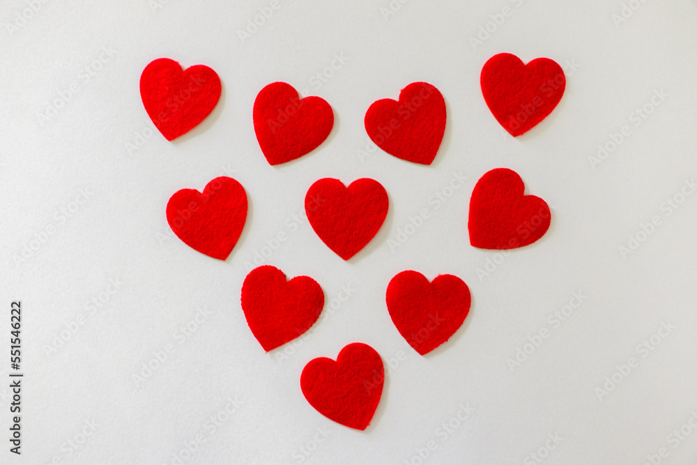 10 Valentine’s day red cotton hearts in a heart shape. Love, valentine’s day, celebration concept.