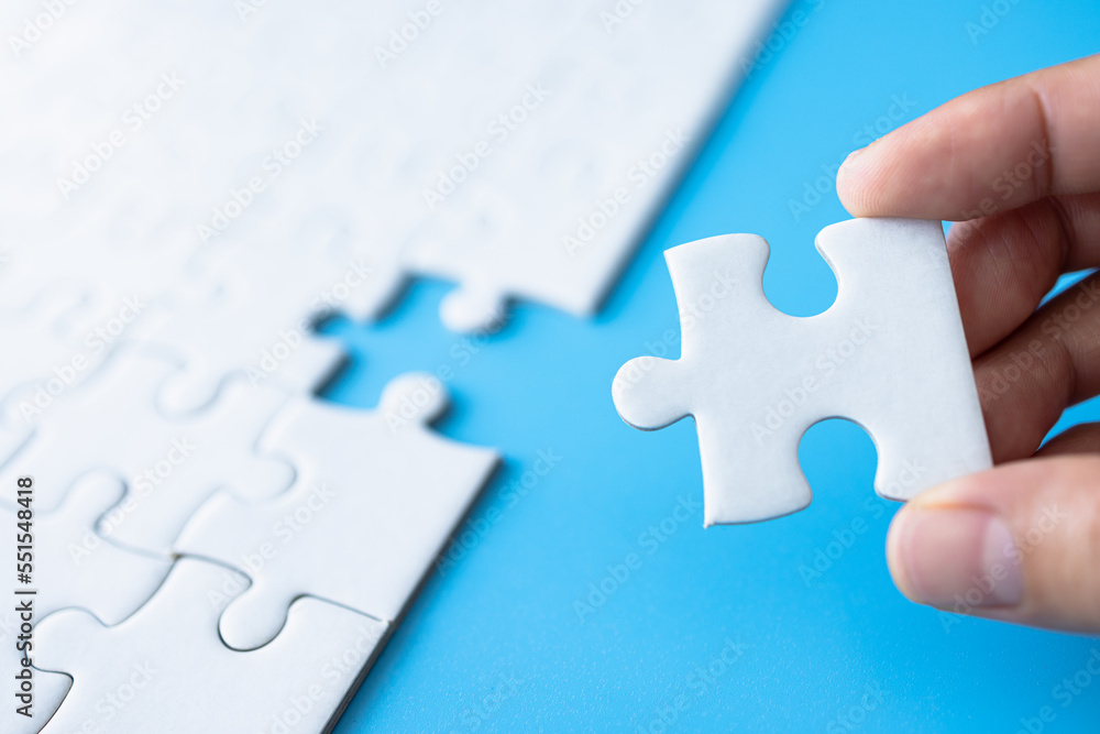 Closeup hand of woman connecting jigsaw puzzle, Business solutions, success and strategy concept. Closeup hand of woman connecting jigsaw puzzle, Business solutions, success and strategy concept.