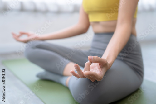 Young woman exercising at home, Meditation and exercise with yoga.