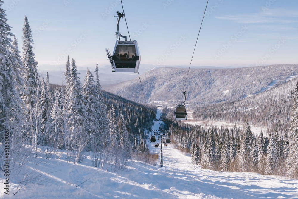 gondola ski lift in mountain ski resort, winter day, snowy spruce forest gondola ski lift in mountain ski resort, winter day, snowy spruce forest