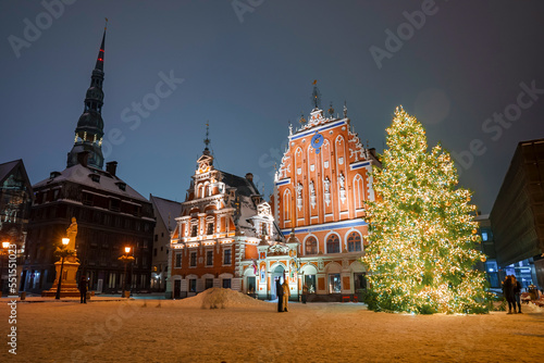 People enjoy Christmas market in winter Riga in Latvia. Magical European Christmas market. © Aerial Film Studio
