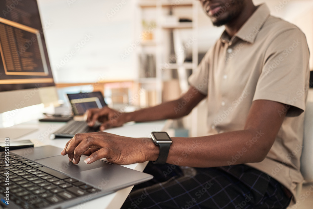 Software developer wearing smartwatch when working on computer in office Software developer wearing smartwatch when working on computer in office