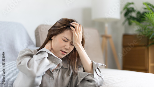 Stressed woman holding her temples with severe problems in her life, Family problems, Pressure from work, Poor financial, Despair in life, discouraged and deeply saddened, Panic attacks.