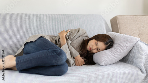 Woman lying chills with high fever on sofa, Severe illness, Headache, Sore throat, High fever, Not taking care of your physical health and not exercising causes your immune system to be low...