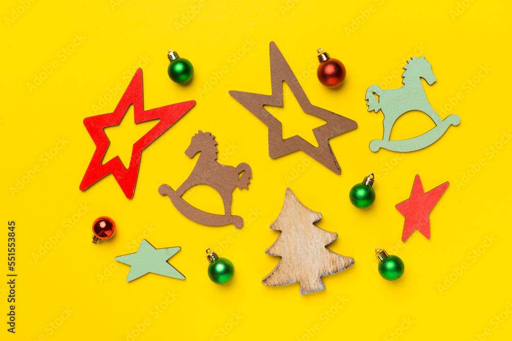 Obraz premium Wooden Christmas toys on color background, top view
