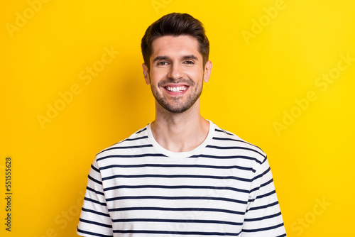 Portrait of satisfied smiling cheerful guy wear trendy stylish striped t-shirt toothy beaming smile after barber isolated on yellow color background