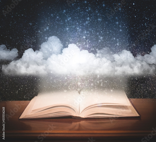 Open book with space and clouds. Fairy tale concept.