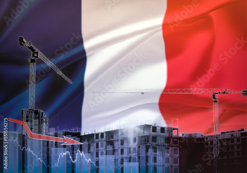 Construction cranes on the background of the flag of France. The concept of a crisis in construction.