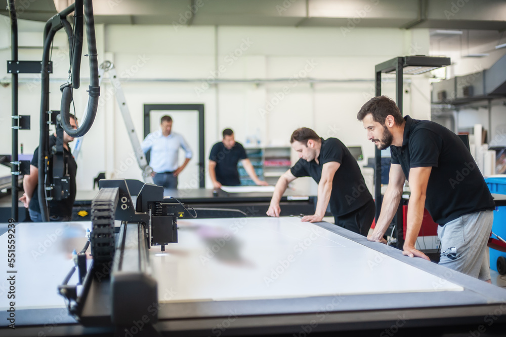Professional workers graphic technicians operators work in a printing
