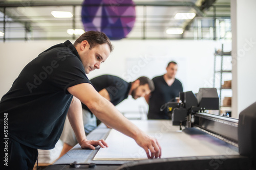 Obraz na płótnie Professional workers graphic technicians operators work in a printing press and