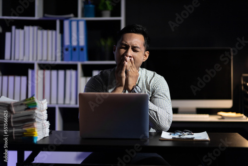 Business people in the night office who work overtime are sleepy and tired from overwork.