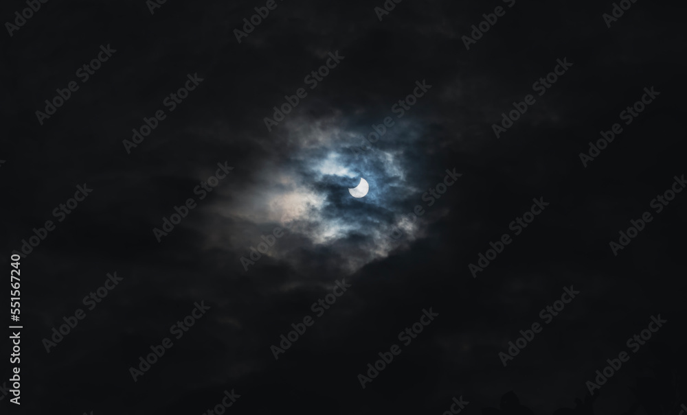 Solar eclipse on the sky in the clouds, scientific astrological background Solar eclipse on the sky in the clouds, scientific astrological background