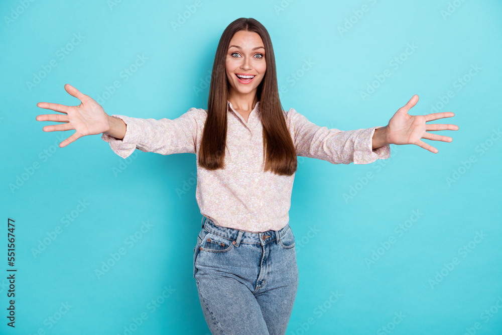 Photo of hooray young woman hug camera wear pink shirt isolated on blue color background Photo of hooray young woman hug camera wear pink shirt isolated on blue color background