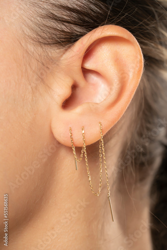 Female ear with three ear chaines.