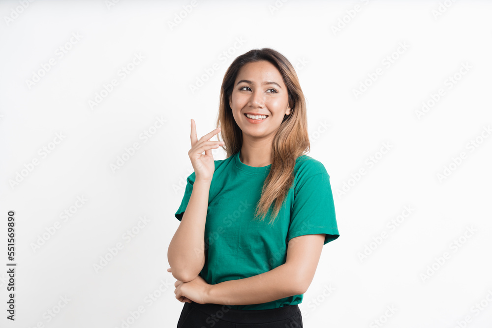 Young asian woman pointing at your product and looks at it isolate on white background. Young asian woman pointing at your product and looks at it isolate on white background.