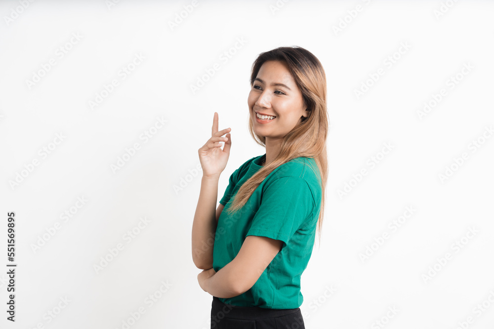 Young asian woman pointing at your product and looks at it isolate on white background. Young asian woman pointing at your product and looks at it isolate on white background.