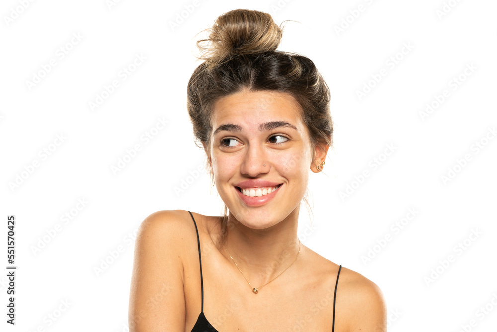 smiling woman with messy loose bun and no makeup on a white studio background. front view smiling woman with messy loose bun and no makeup on a white studio background. front view