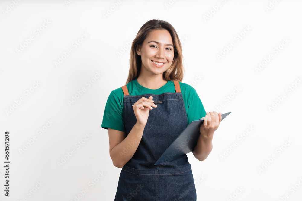 Charming young Asian businesswoman owner wearing an apron holding With clipboard front of an isolated over white background. Charming young Asian businesswoman owner wearing an apron holding With clipboard front of an isolated over white background.