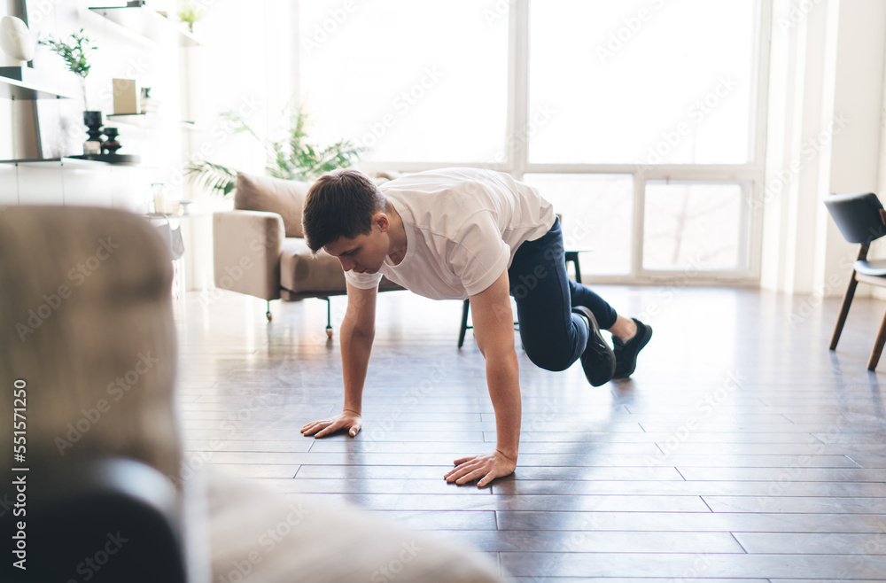 Fototapeta premium Sportsman doing running plank exercise during workout
