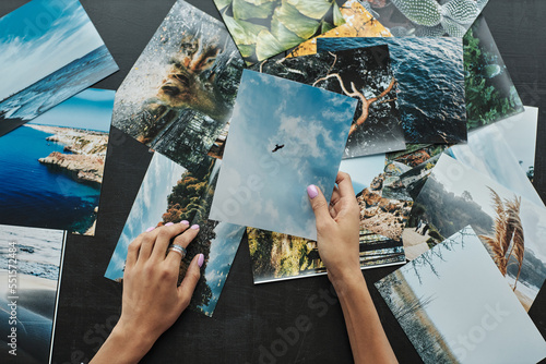 Εκτύπωση καμβά Magazine editor choosing photos for new issue, view from above